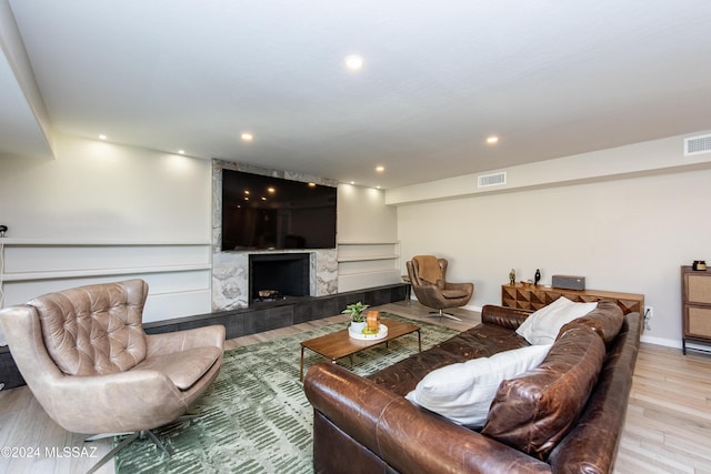 living room with a fireplace and light hardwood / wood-style floors