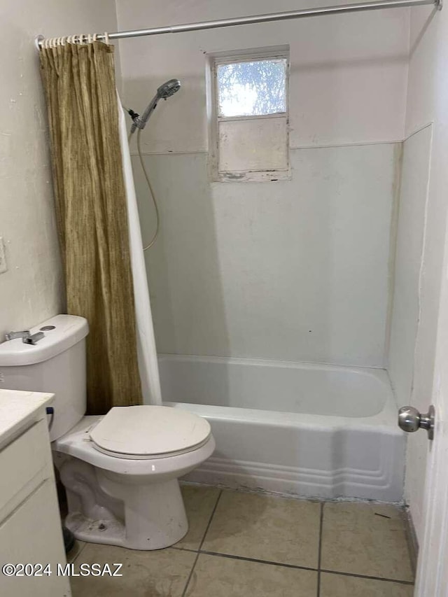 full bathroom with toilet, vanity, tile patterned floors, and shower / bath combo with shower curtain