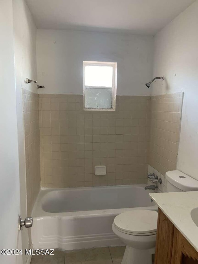 full bathroom with toilet, vanity, tile patterned floors, and tiled shower / bath