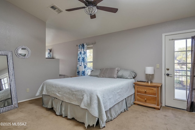 bedroom featuring multiple windows, ceiling fan, and light carpet