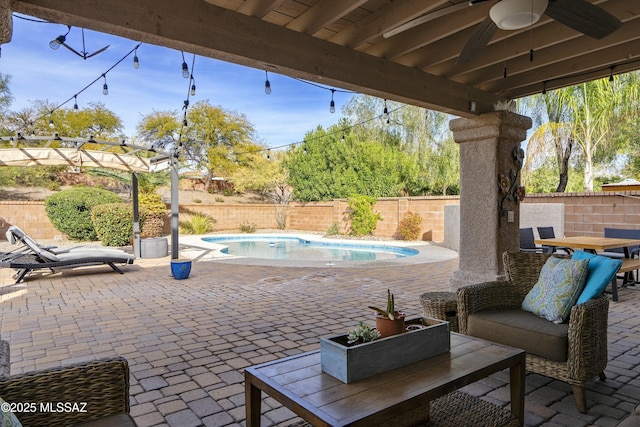 view of patio / terrace featuring a fenced in pool and ceiling fan