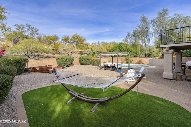 view of yard featuring a fenced in pool, a pergola, and a patio