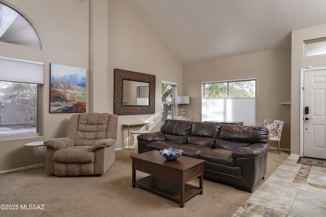 carpeted living room featuring high vaulted ceiling