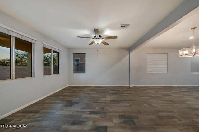 unfurnished room with ceiling fan with notable chandelier