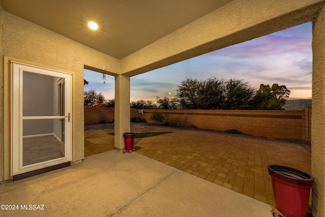 view of patio terrace at dusk