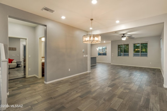 interior space with ceiling fan with notable chandelier and dark hardwood / wood-style floors