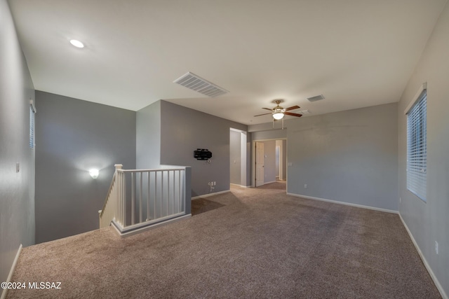 unfurnished room with ceiling fan and carpet floors