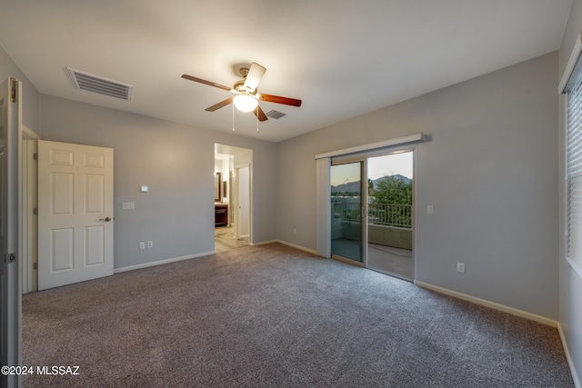 interior space featuring ceiling fan, access to exterior, ensuite bathroom, and light carpet