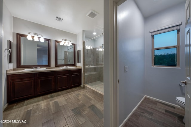 bathroom with hardwood / wood-style flooring, toilet, and walk in shower