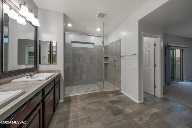 bathroom featuring vanity and a tile shower