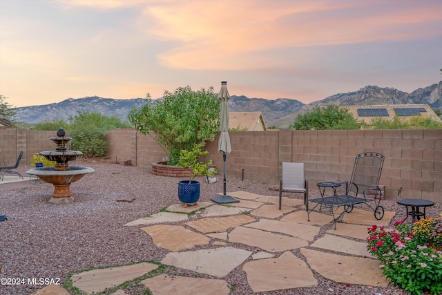 view of patio with a fenced backyard and a mountain view