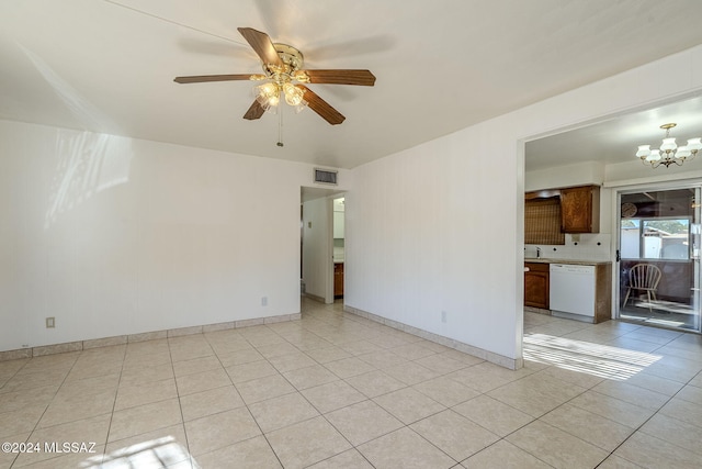 tiled empty room featuring sink and ceiling fan with notable chandelier