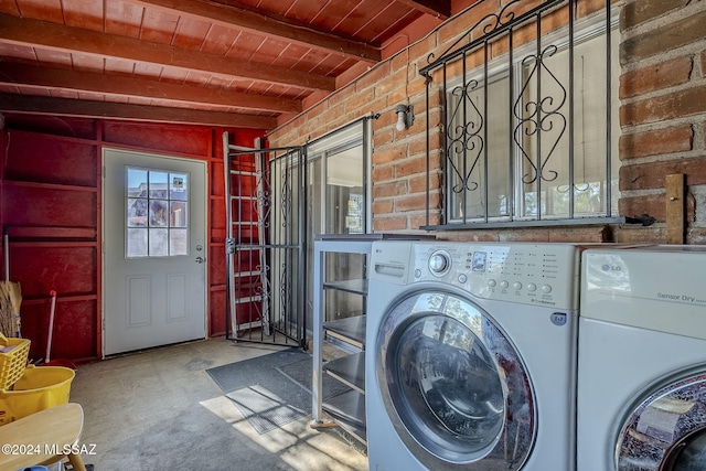 laundry room with wooden ceiling and washing machine and clothes dryer