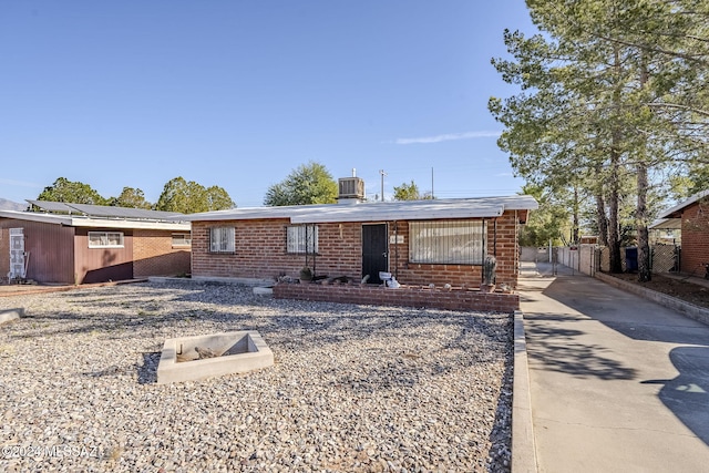 ranch-style home featuring cooling unit