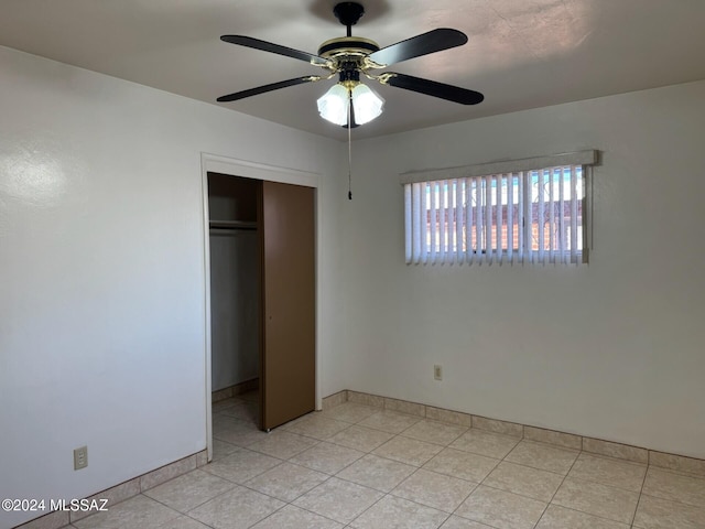 unfurnished bedroom featuring a closet and ceiling fan