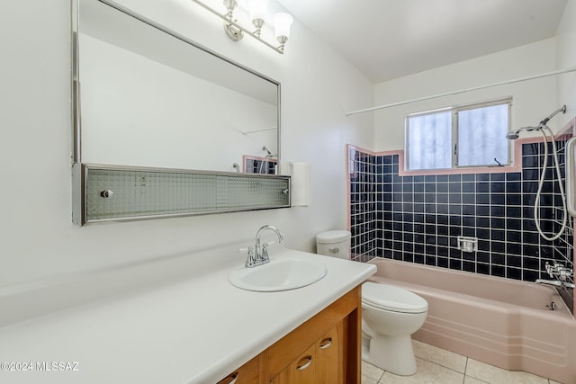 full bathroom featuring tile patterned flooring, vanity, toilet, and tiled shower / bath