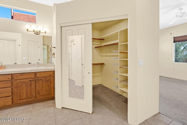 bathroom featuring tile patterned flooring, vanity, and ceiling fan