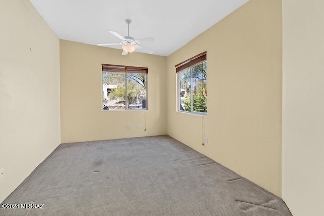 spare room with light carpet and ceiling fan