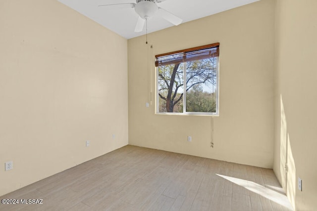 spare room featuring ceiling fan and light wood-type flooring