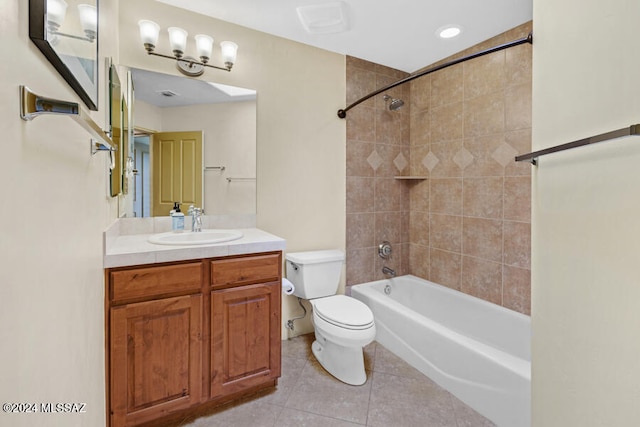 full bathroom featuring tile patterned flooring, vanity, toilet, and tiled shower / bath