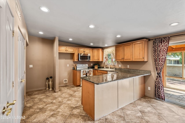 kitchen featuring kitchen peninsula, electric stove, dark stone counters, and lofted ceiling