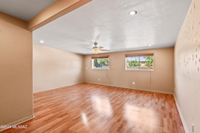 spare room featuring ceiling fan and light wood-type flooring