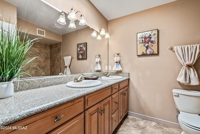 bathroom featuring tile patterned flooring, vanity, and toilet