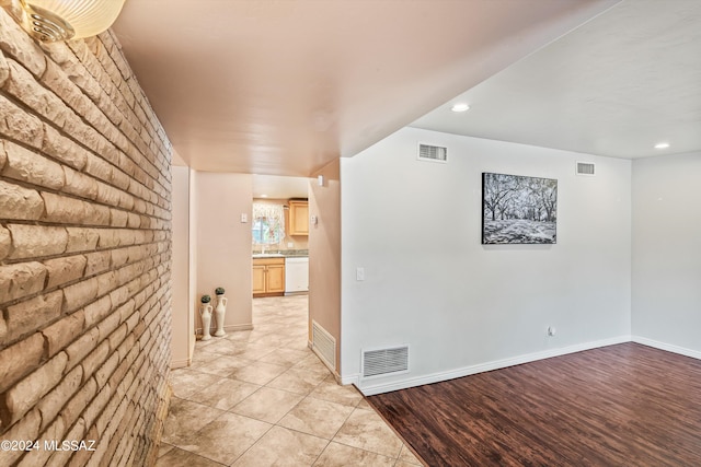 hall with sink and light wood-type flooring