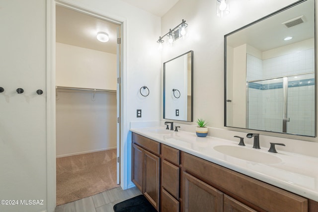 6551 E Via Arroyo Largo, Tucson, AZ 85756 - bathroom with double vanity, a shower stall, and a spacious closet