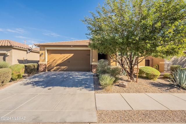 6551 E Via Arroyo Largo, Tucson, AZ 85756 - view of front of home featuring stucco siding, a garage, driveway, and a tiled roof