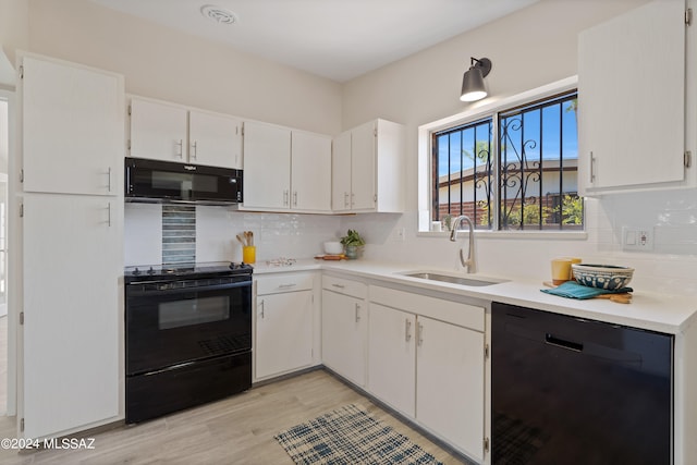 kitchen with black appliances, sink, decorative backsplash, light hardwood / wood-style floors, and white cabinetry