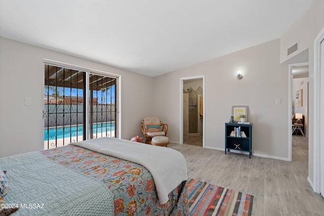 bedroom featuring access to exterior, light wood-type flooring, and ensuite bathroom