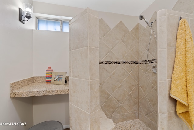 bathroom with a tile shower