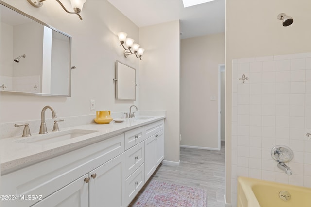 full bathroom with wood-type flooring, vanity, toilet, and tiled shower / bath