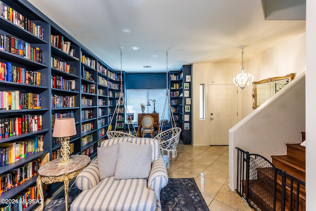 sitting room with an inviting chandelier and light tile patterned flooring