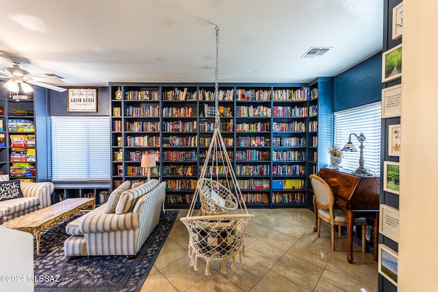 sitting room with tile patterned flooring and ceiling fan