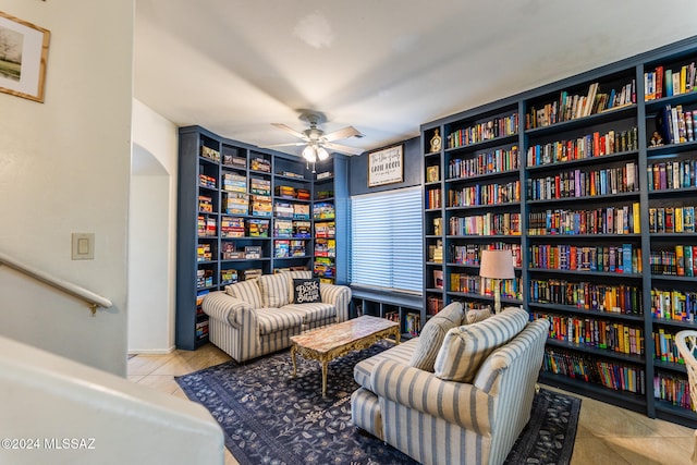 living area with ceiling fan and light tile patterned floors