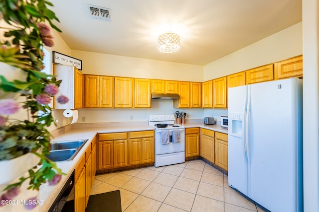 kitchen featuring white appliances and light tile patterned floors