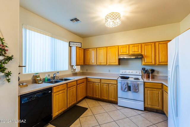 kitchen featuring light tile patterned flooring, white appliances, and sink