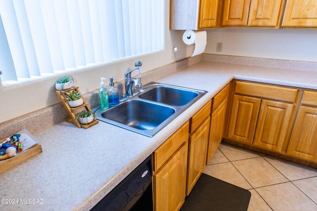 kitchen featuring dishwasher, light tile patterned floors, and sink