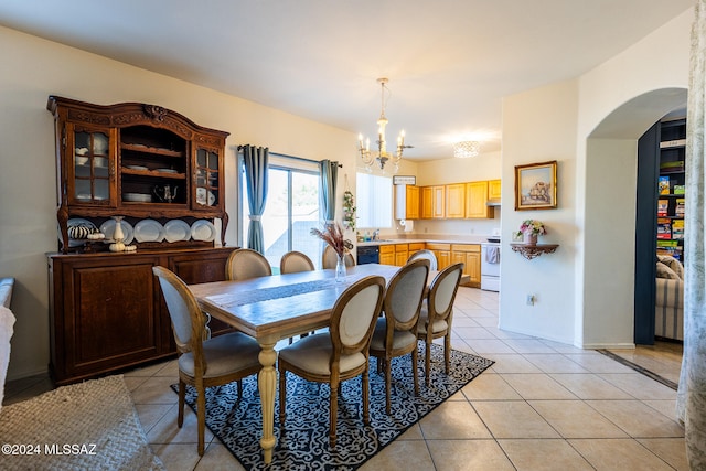 tiled dining room featuring a notable chandelier and sink