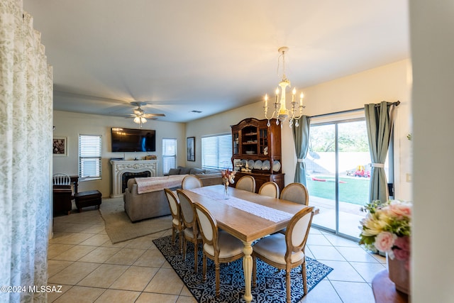 dining room with ceiling fan with notable chandelier and light tile patterned flooring