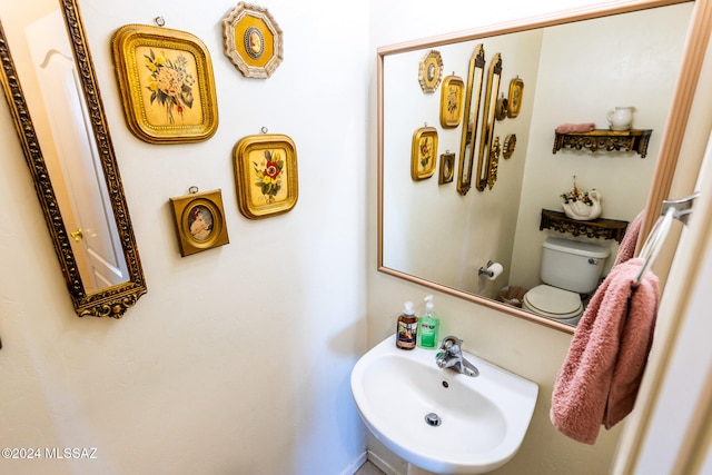 bathroom with toilet and sink