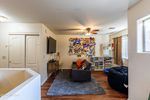 interior space with ceiling fan and dark wood-type flooring