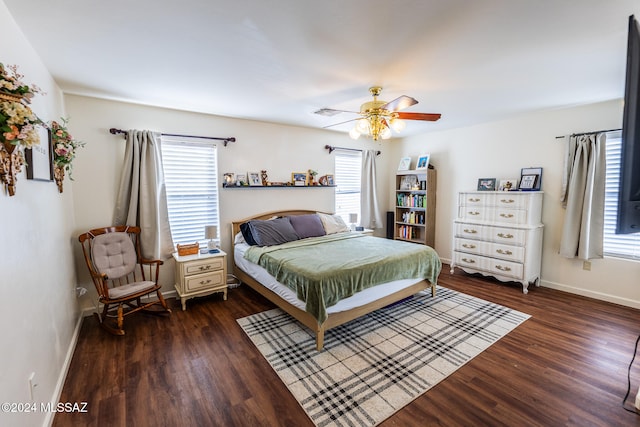 bedroom with ceiling fan, dark hardwood / wood-style flooring, and multiple windows