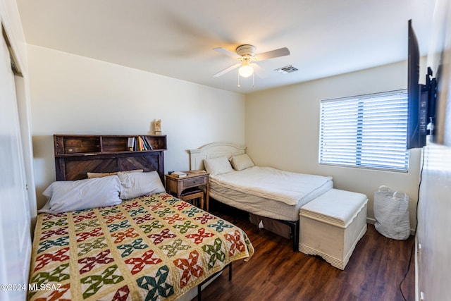 bedroom featuring a closet, dark hardwood / wood-style floors, and ceiling fan