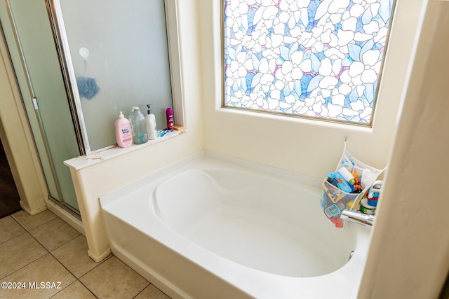 bathroom featuring tile patterned flooring and separate shower and tub