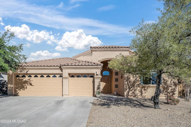 mediterranean / spanish house featuring a garage