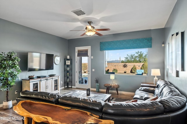 living room with hardwood / wood-style flooring and ceiling fan