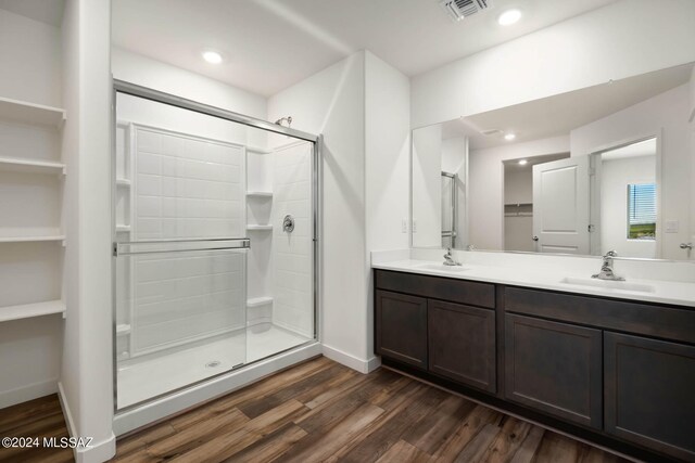 bathroom featuring vanity, wood-type flooring, and an enclosed shower